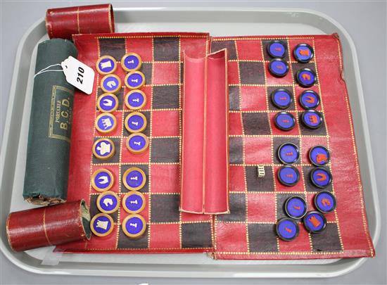 A 19th century Jaques Patent portable B.C.D. backgammon, chess and draughts board set, the gilt tooled red morocco cylinder holder